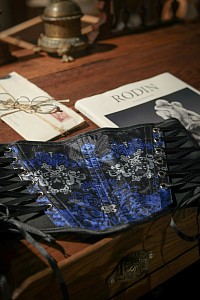 A average blue corset on a wooden desk